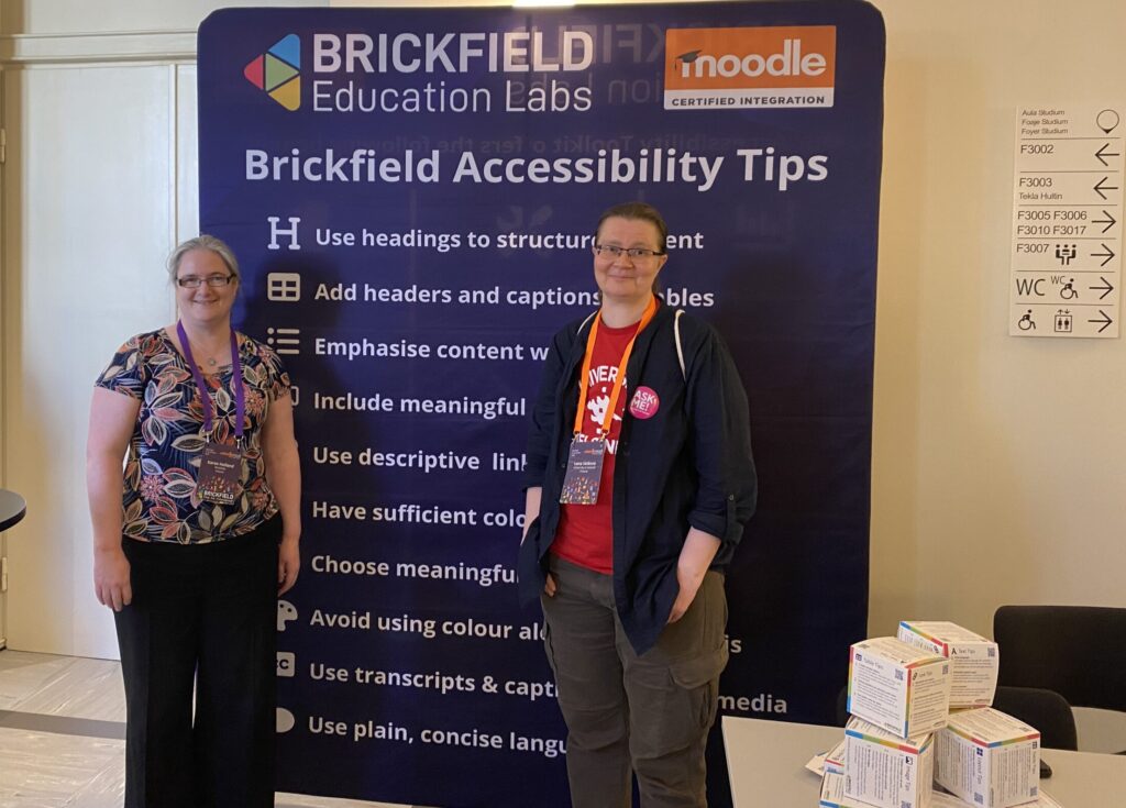 Karen Holland (Brickfield) and Lena Selanne (University of Helsinki) standing in front of the Brickfield Accessibility Tips Banner