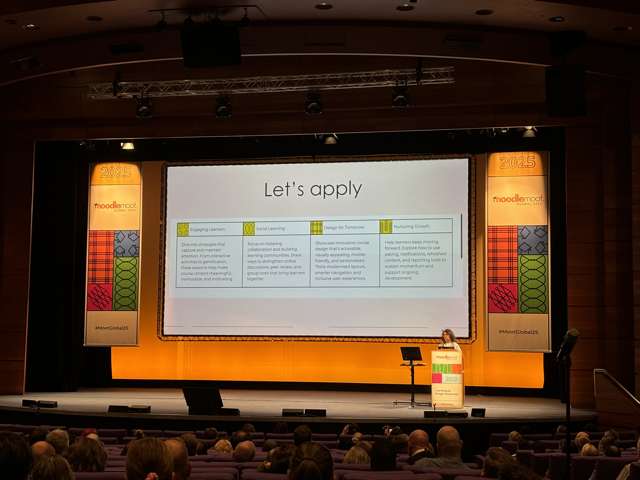 A large auditorium with attendees sat in seated rows facing a brightly lit stage. On the stage is a large screen which displays a slide titled “Let’s apply.” The slide features four coloured sections labelled “Engaging Learners”, “Social Learning”, “Design for Tomorrow”, and “Nurturing Growth”, each describing strategies for effective teaching and learning. Dr Neema Pasha stands at a podium on the right side of the stage under orange lighting with MoodleMoot Global 2025 branding on both sides of the screen.