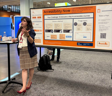 Kate Bengston stands beside a large poster titled “Accessibility Now: Light-Lift Retrofitting of Your Digital Learning Spaces for Greater Access.” The Moodle logo appears on the poster, with text and diagrams visible.