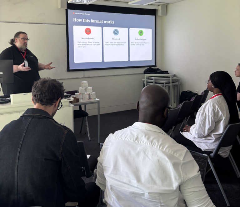 Gavin Henrick, CEO and co-founder of Brickfield Education Labs, presenting to a group of participants, with a slide titled 'How this format works' displayed on the screen behind him.